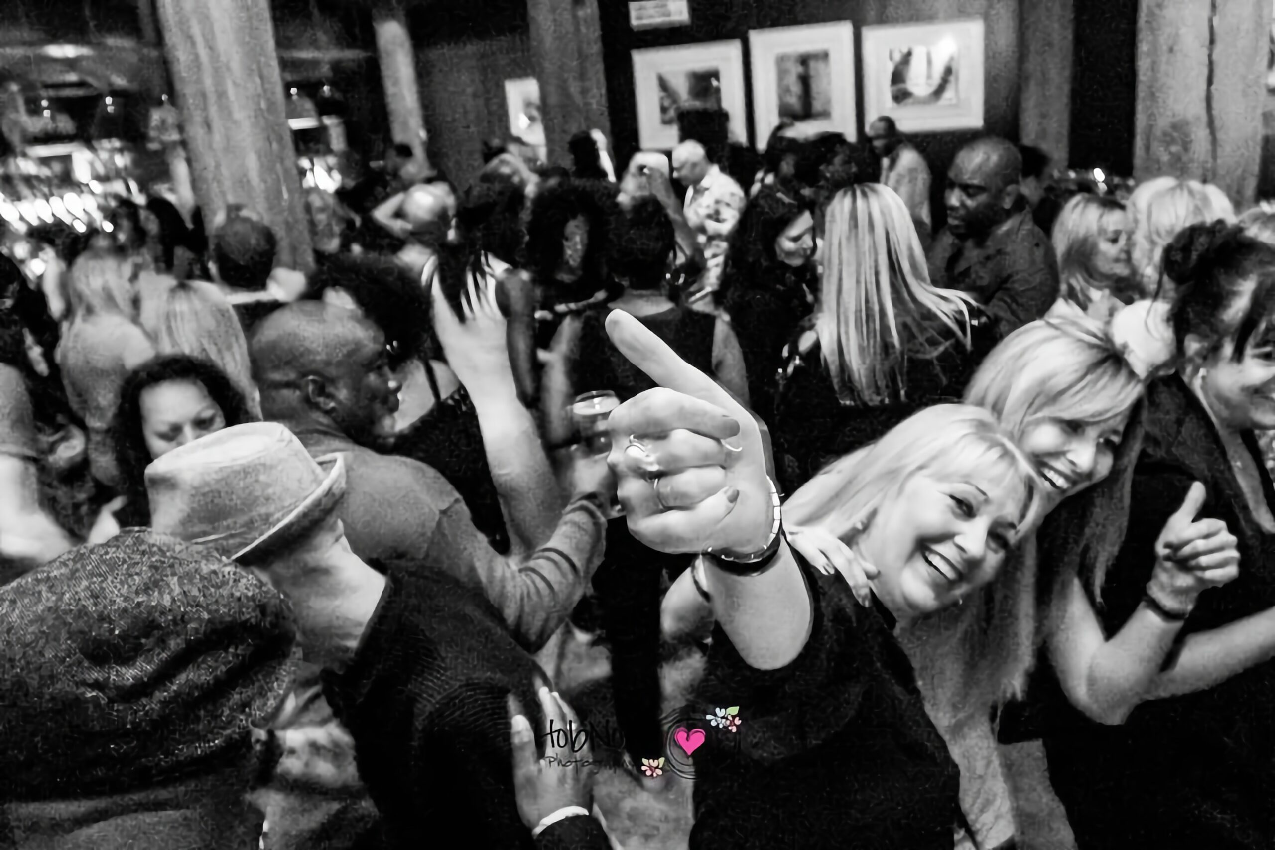 Smiling women dancing and pointing during a Soul Fiesta event in Essex.