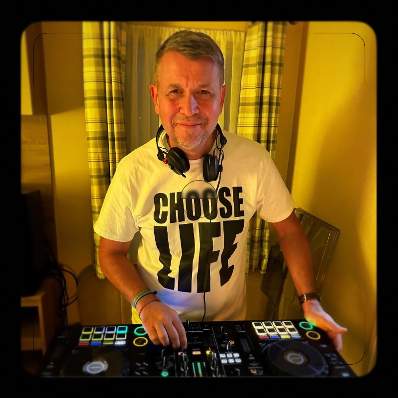 Steve Kite DJing with a “Choose Life” tee at a vibrant indoor event.